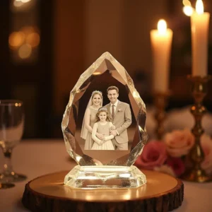 Transparent crystal with engraved couple or family photo, illuminated from the side, placed on a stand with a warm, romantic background, symbolizing lasting memories